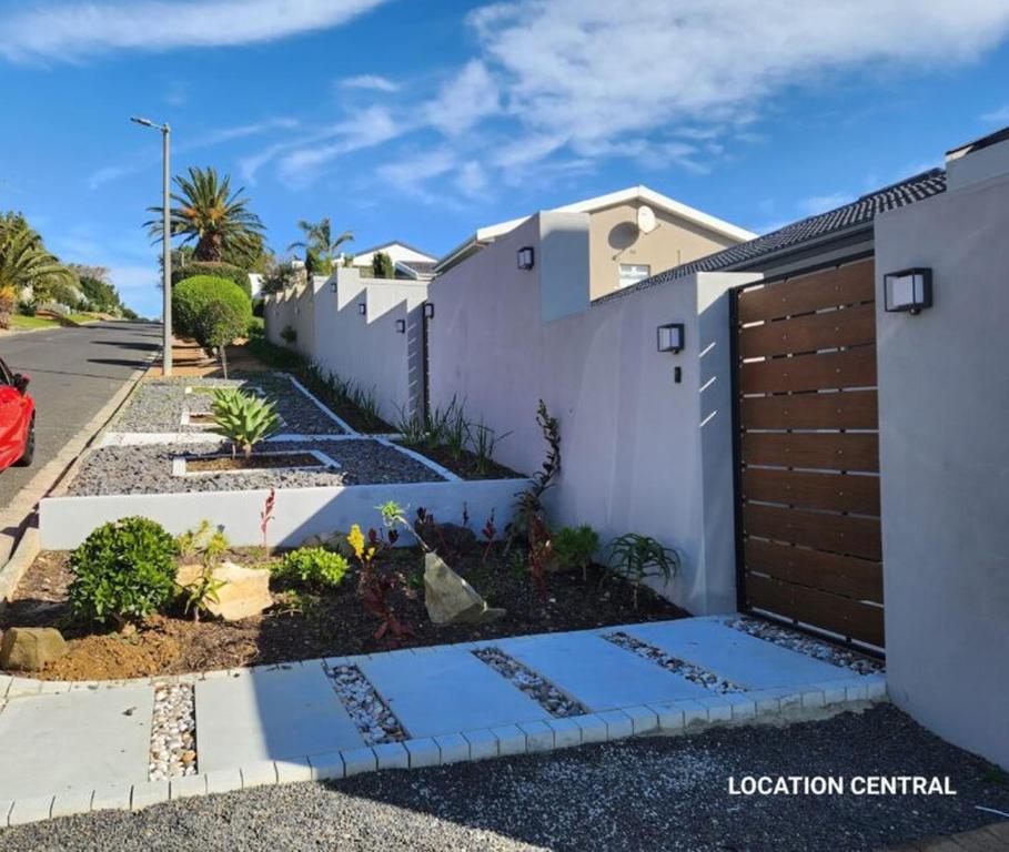 a white house with a fence and a driveway at Modern, Comfy Guest Suite with Beautiful Views in Tygerberg Hills