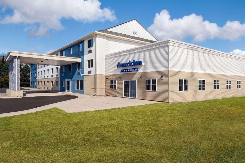 a building with aania sign on the side of it at AmericInn by Wyndham Dodgeville in Dodgeville