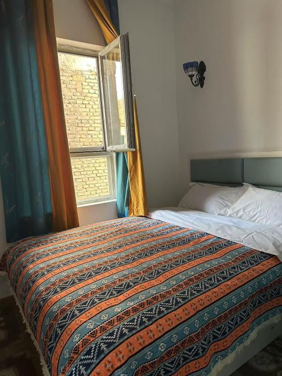 Postel nebo postele na pokoji v ubytování 喀什幸福旅居民宿