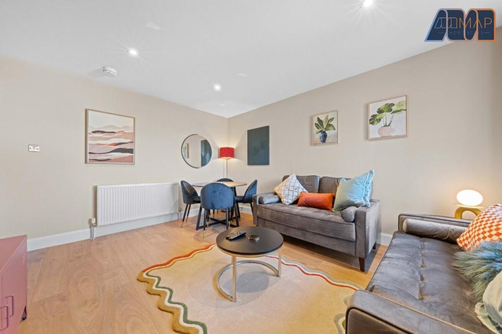 a living room with a couch and a table at 2 Bed Sleeps 4 in Dunfermline in Cairneyhill