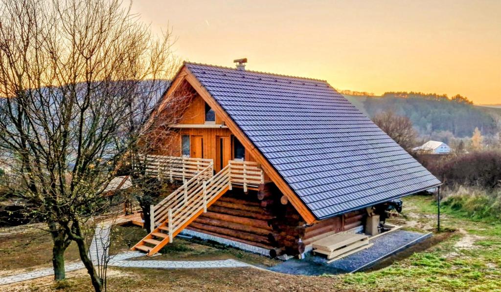 a log cabin with a staircase leading up to it at Apartmany Nemo in Nemotice