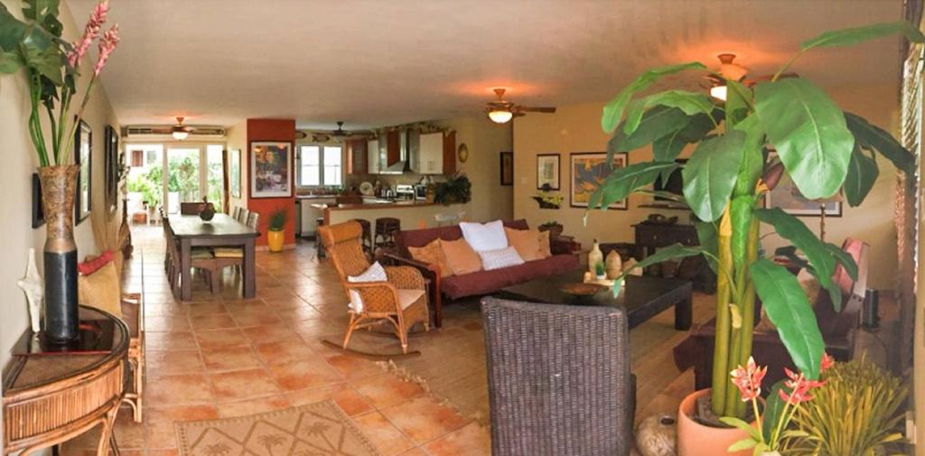 a living room with a couch and a table at A Dream Condo With Private Pool At 7 Seas Beach in Fajardo