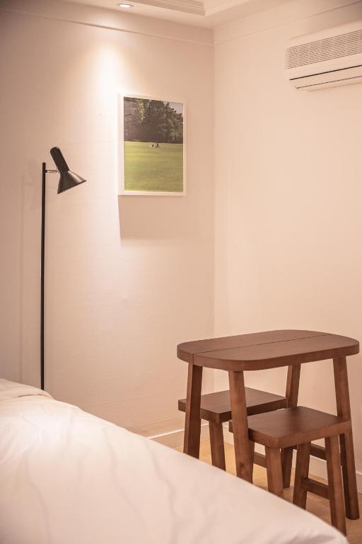 a bedroom with a table next to a bed at Stay A Hotel Gwangan in Busan