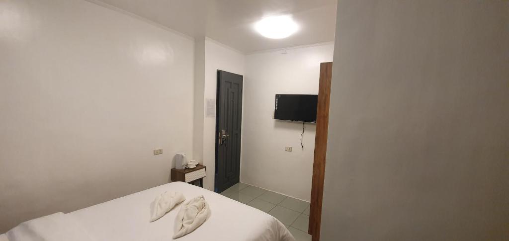 Postel nebo postele na pokoji v ubytování AJ Tourist Inn