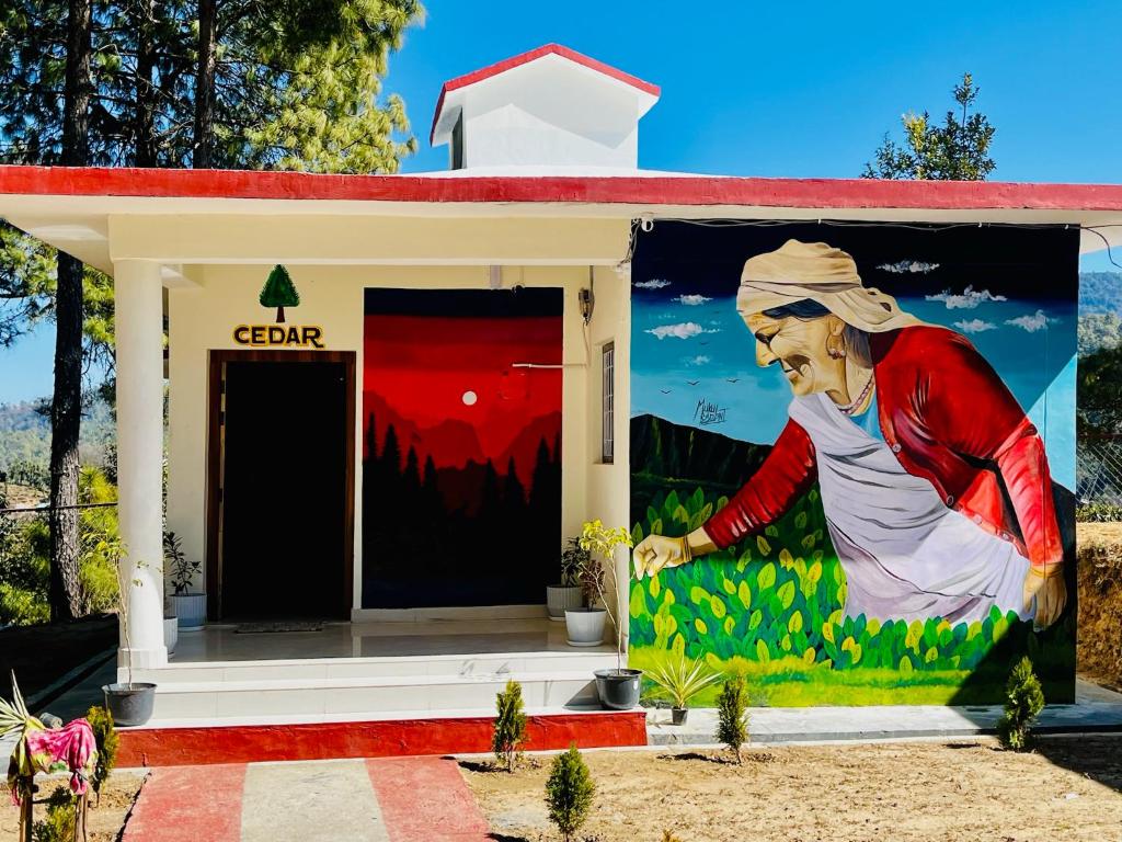 a mural on the side of a building at The Golden Leaves Cafe And Cottages in Champawat
