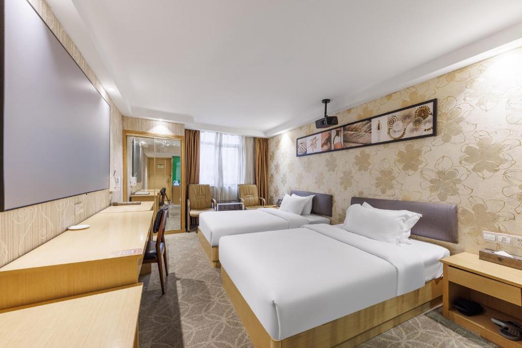 Postel nebo postele na pokoji v ubytování Fuhao Hotel