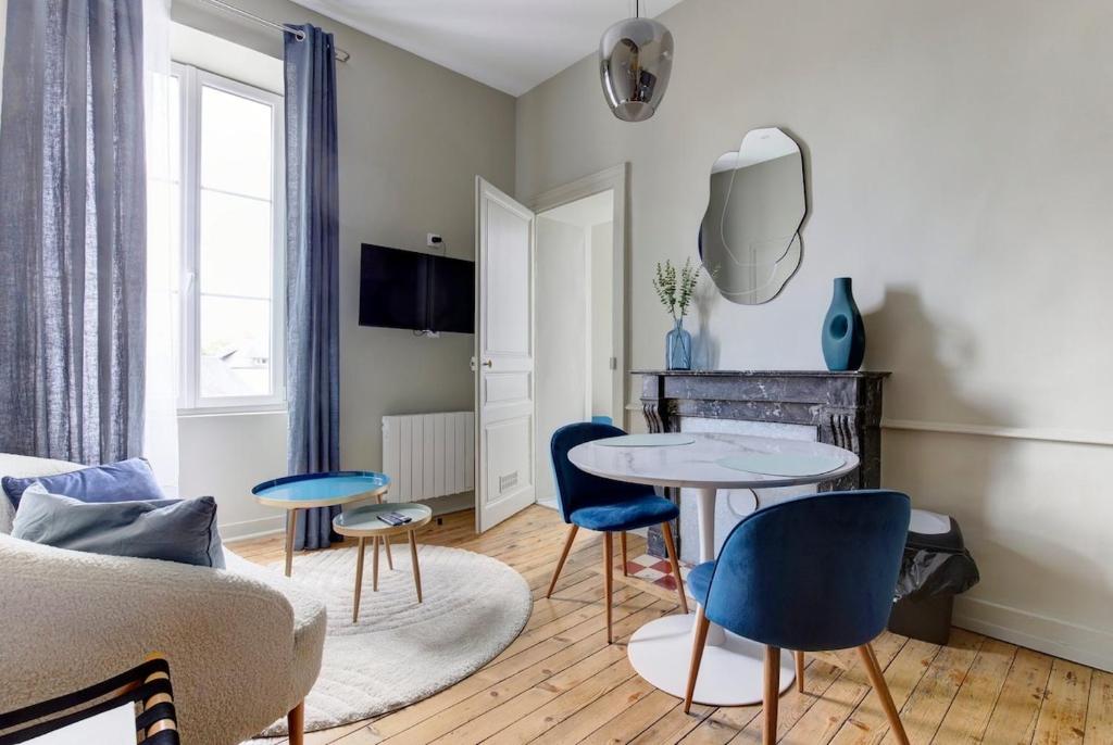 un salon avec une table et des chaises dans l'établissement Appartement Laval Centre, à Laval