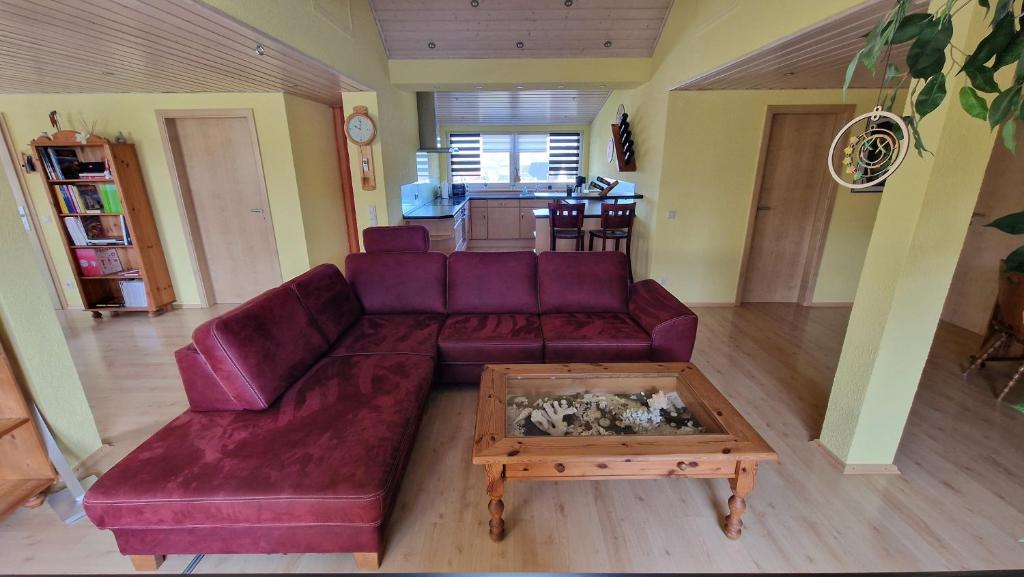 a living room with a purple couch and a coffee table at Ferienwohnung Wiesental II, Wiesentalstrasse 1, 89331 Burgau in Burgau