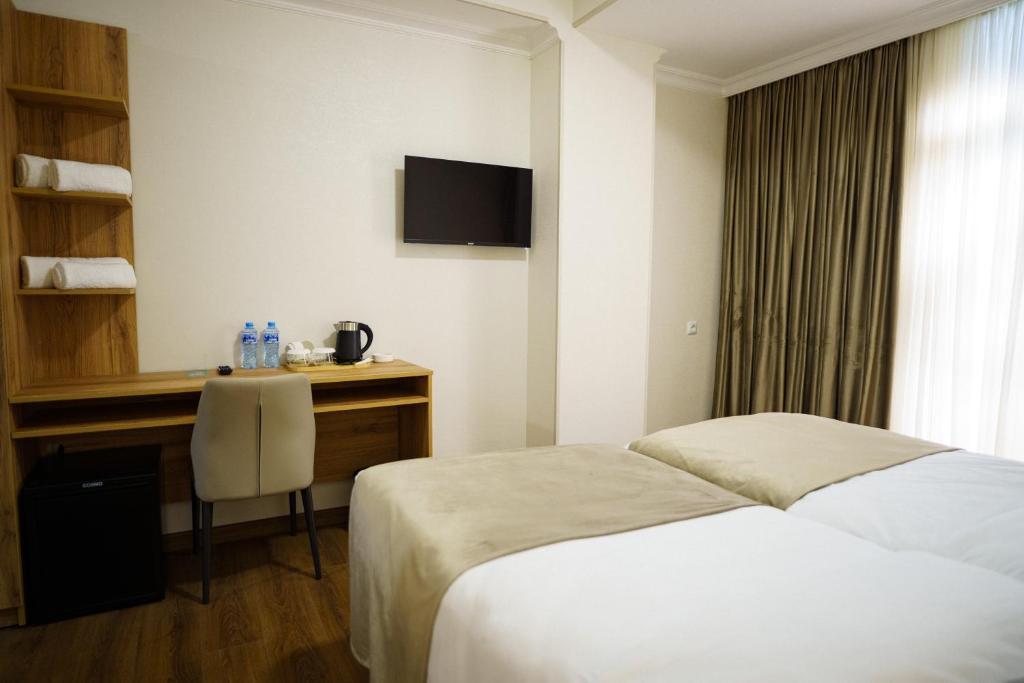 Postel nebo postele na pokoji v ubytování Green Palace Kutaisi