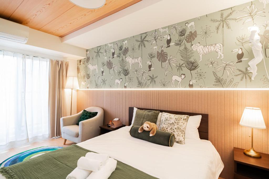 a hotel room with a bed and a chair at QUEENS PARK in Osaka