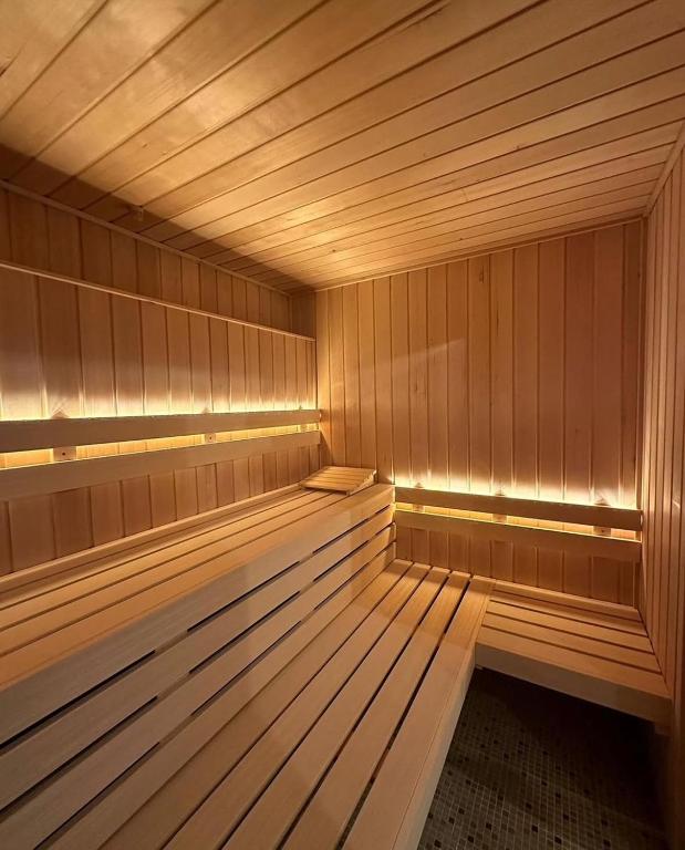 an empty wooden sauna with a wooden floor and wooden floors at Hôtel et SPA du Château in Lagord