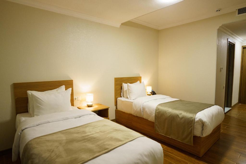 Postel nebo postele na pokoji v ubytování Green Palace Kutaisi