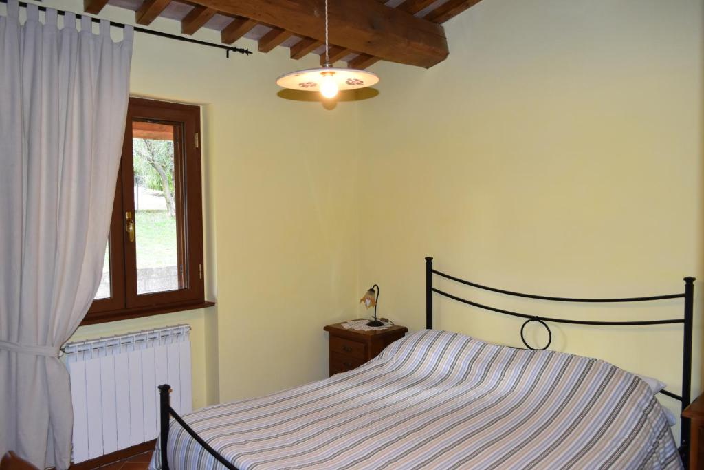 Postel nebo postele na pokoji v ubytování Agriturismo Le Ginestre