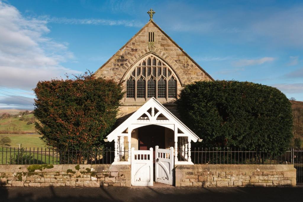a small church with a white gate in front of it at Wesleyan Bolton Abbey Estate in Appletreewick