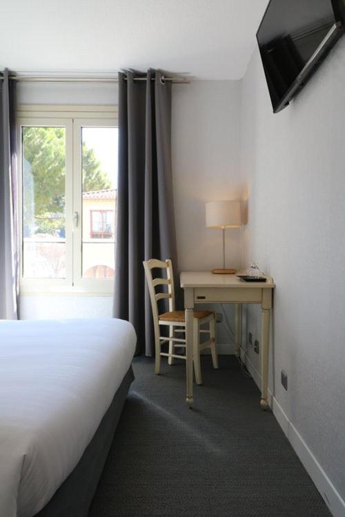 Postel nebo postele na pokoji v ubytování Hôtel Napoléon