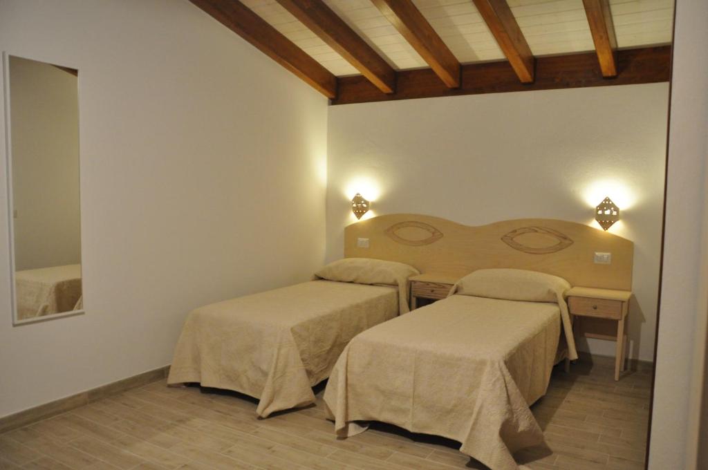 Postel nebo postele na pokoji v ubytování Agriturismo Sa Scalitta