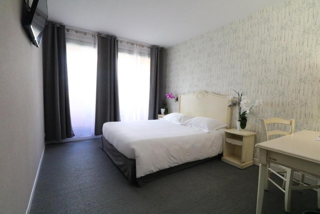 Postel nebo postele na pokoji v ubytování Hôtel Napoléon