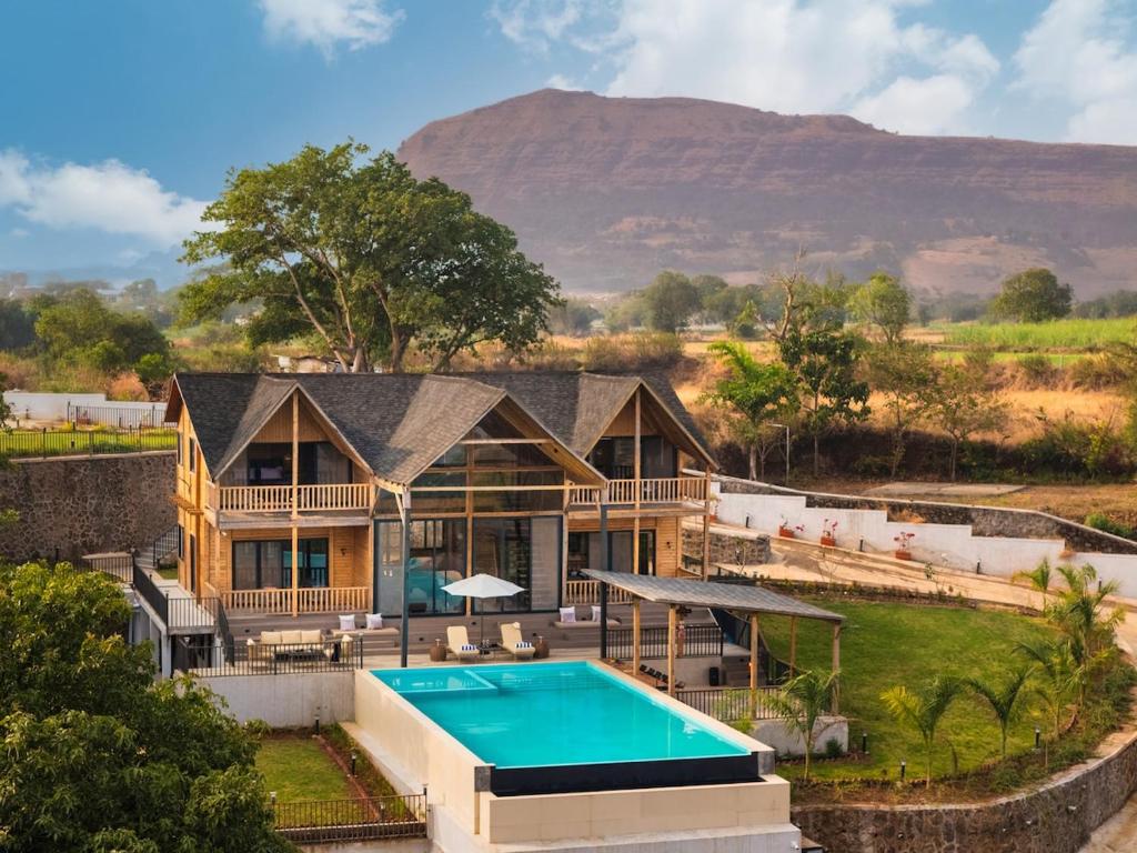 an aerial view of a house with a swimming pool at Stayscape Smultronstalle 6BHK Igatpuri in Zarvar