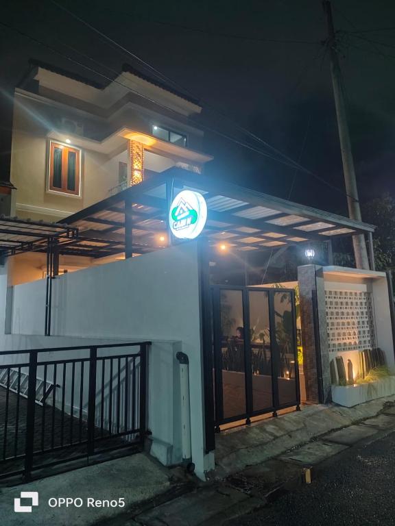 a gas station at night with a sign on it at CABI'N Homestay in Jarakan