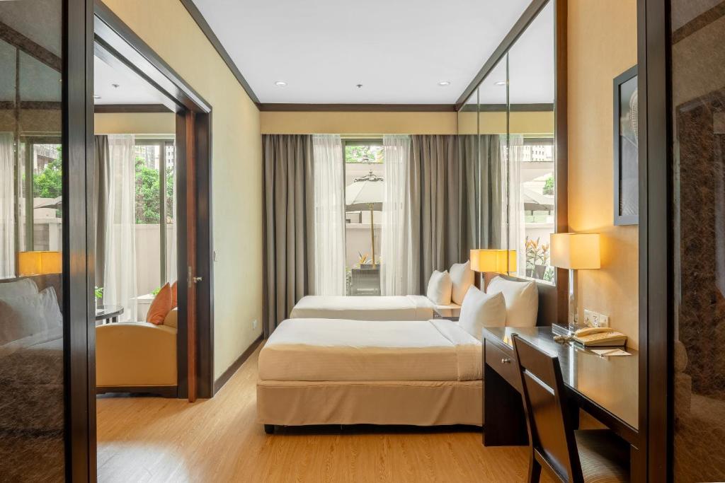 Postel nebo postele na pokoji v ubytování Micasa All Suites Hotel