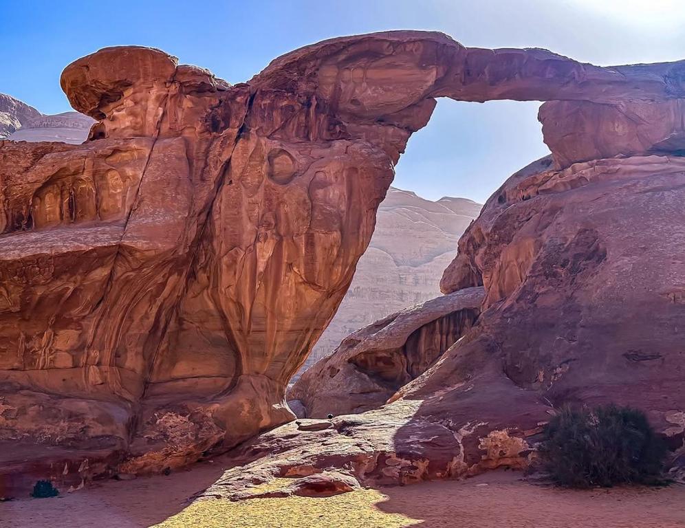 an arch in a rock formation in the desert at Wadi Rum safari camp in Wadi Rum
