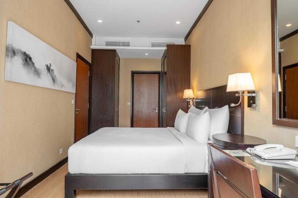 Postel nebo postele na pokoji v ubytování Micasa All Suites Hotel