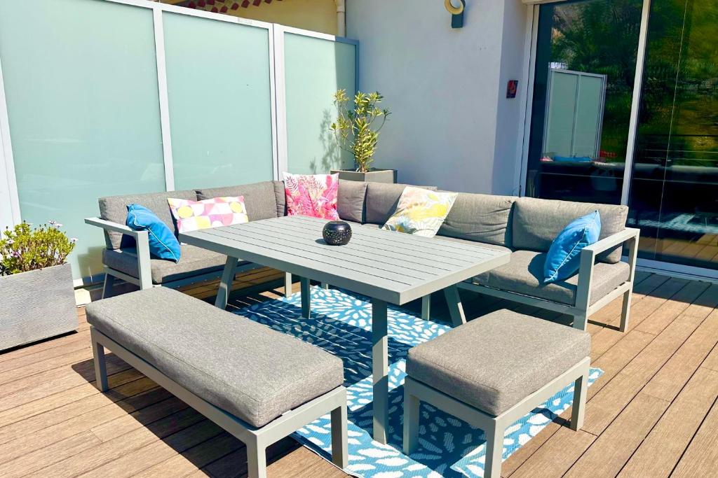 a table and two chairs and a couch on a patio at Peaceful apartment in Cavaillon with garage in Cavaillon