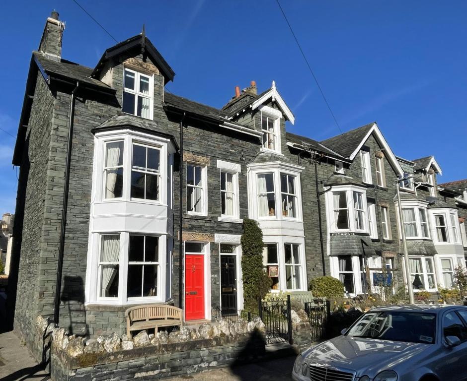 a large brick house with a red door at 45 Eskin Street in Keswick