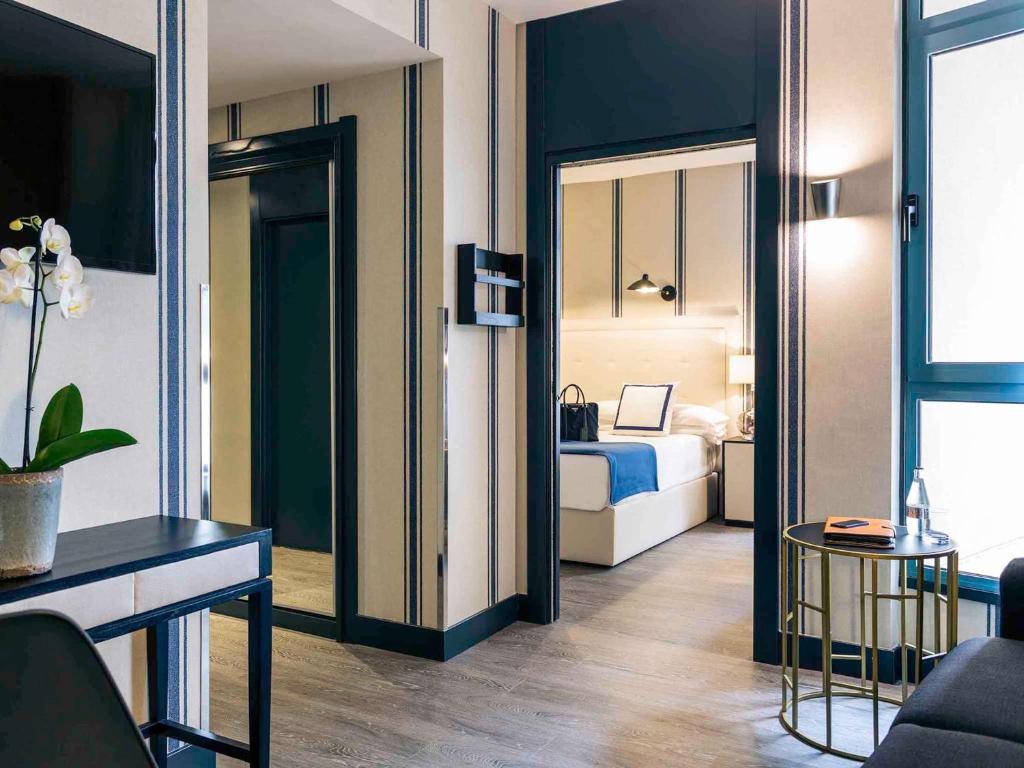 Postel nebo postele na pokoji v ubytování Hotel Mercure Jardines de Albia