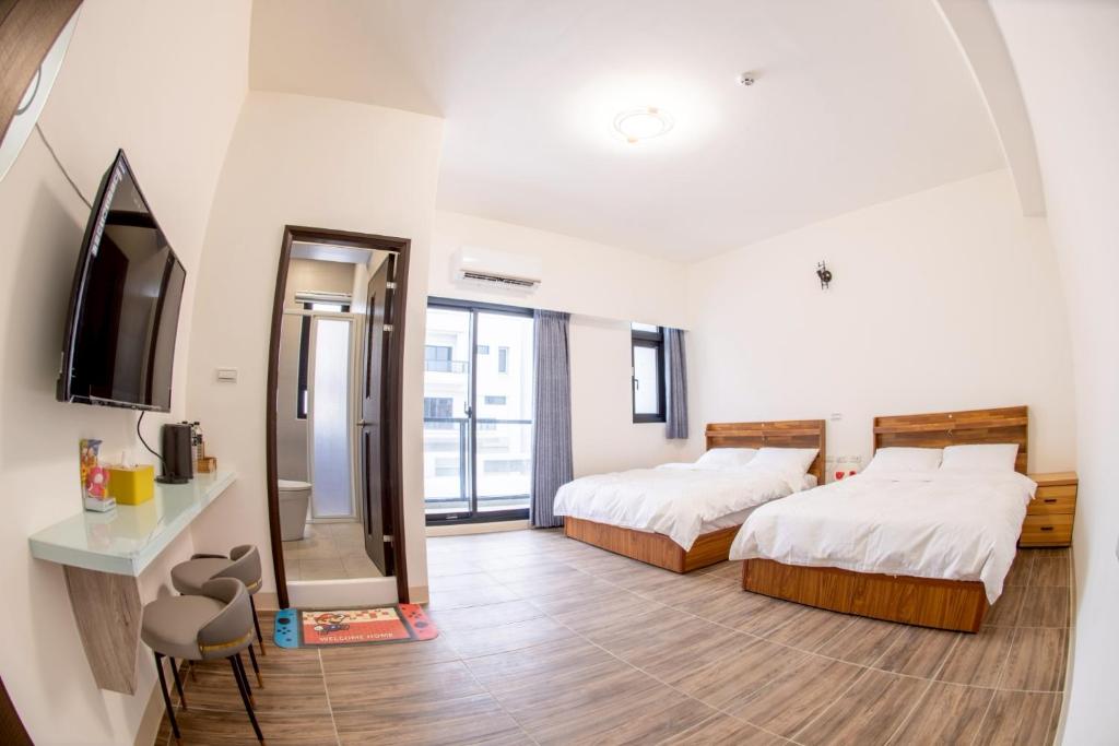 Ένα ή περισσότερα κρεβάτια σε δωμάτιο στο BAOBAO BnB