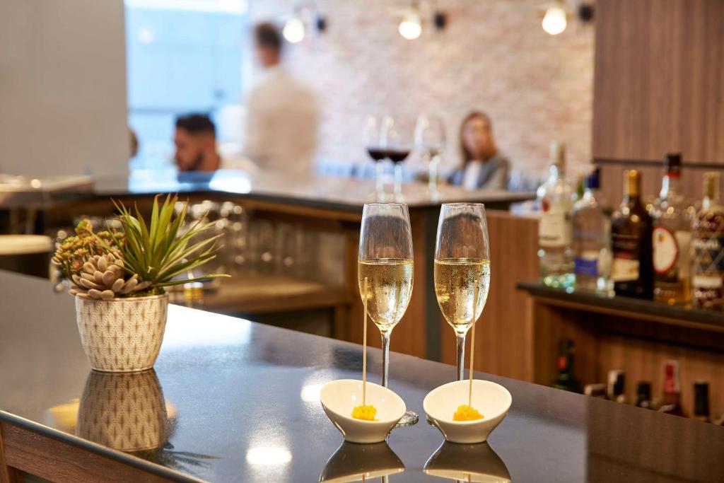 two glasses of champagne on a bar in a restaurant at NH Barcelona Stadium in Barcelona