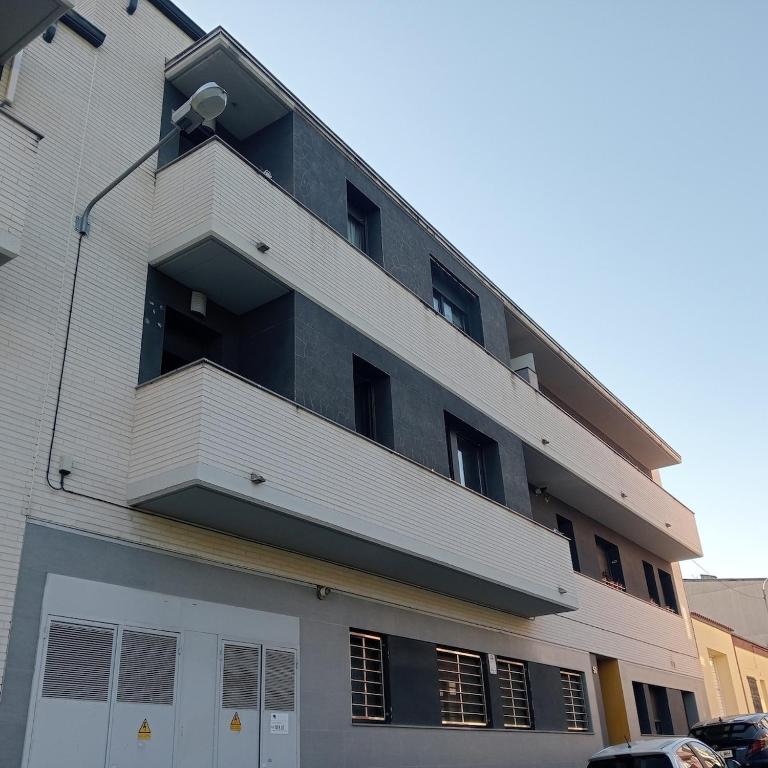 an apartment building with a balcony on the side of it at Apartamento Castellet1 in San Vicente de Castellet