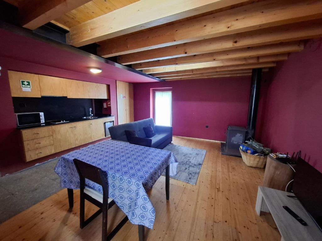 a room with a table and a couch and a kitchen at House 1 in Fafe