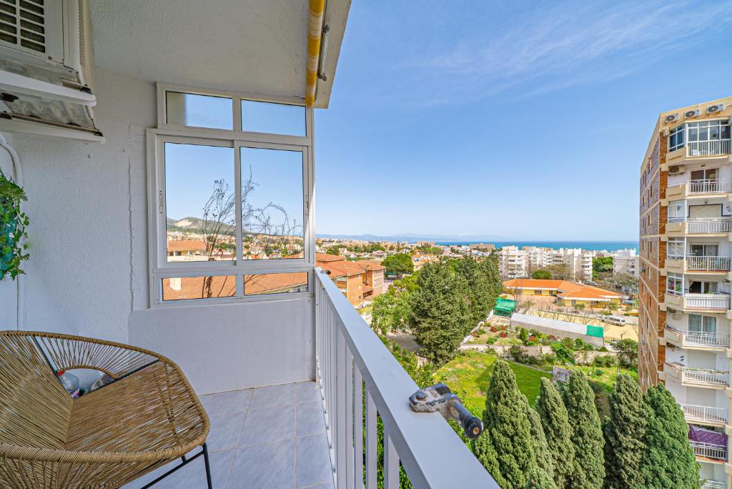 a balcony with a view of a city at Pura Vida King-Size Bed Sea and Mountain view Apartment in Benalmádena