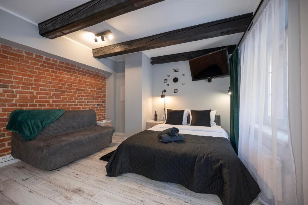 Posteľ alebo postele v izbe v ubytovaní Kościelna Loft Apartaments