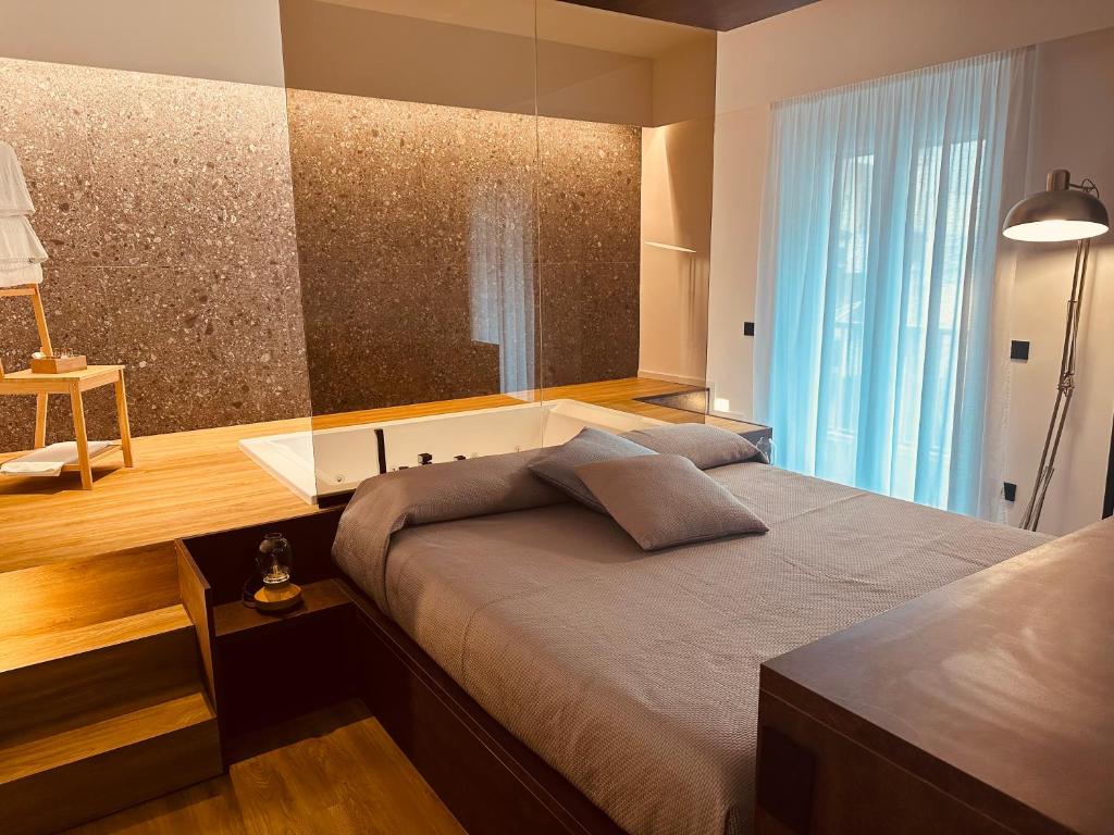 a bedroom with a large bed and a large window at Elegance Rooms Cefalù in Cefalù