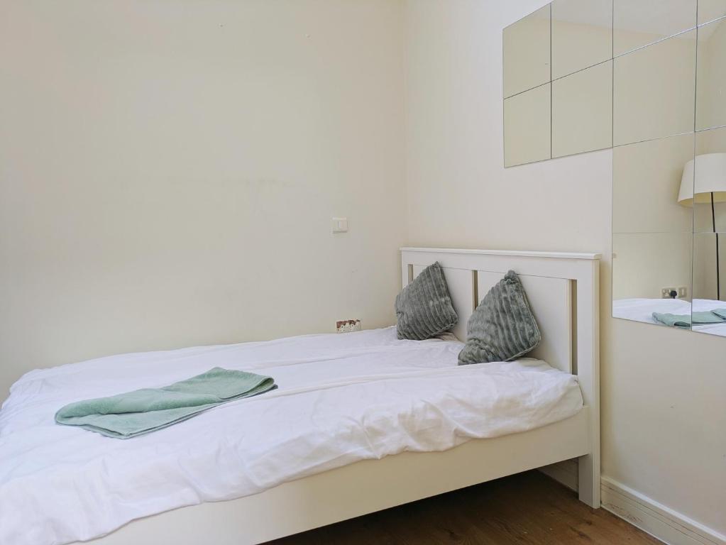 a white bed with two pillows on top of it at Room bhm city centre in Birmingham