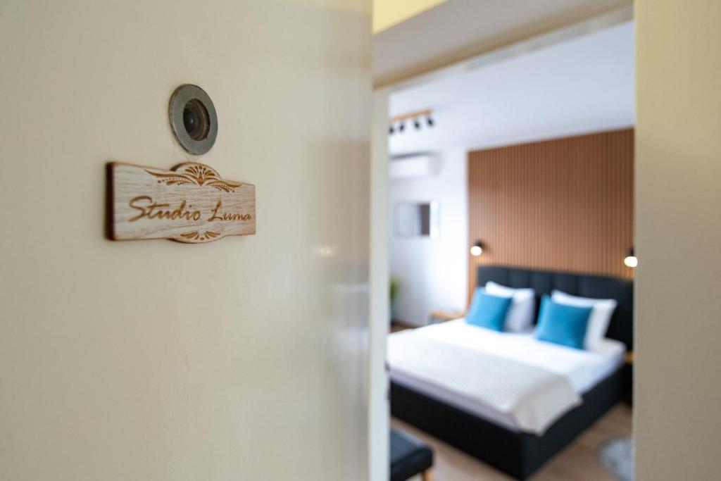 a hotel room with a bed and a clock on the wall at Luma Studio in Dubrovnik