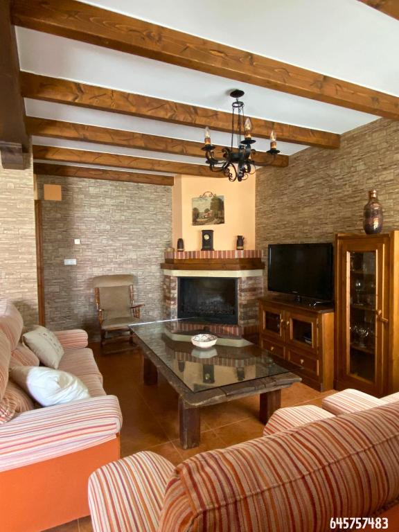 a living room with a couch and a coffee table at La Golondrina in Cáñar
