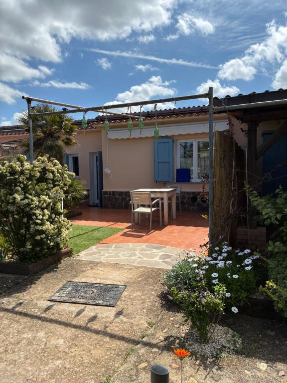 a house with a patio with a table in the yard at Terra in Valledoria