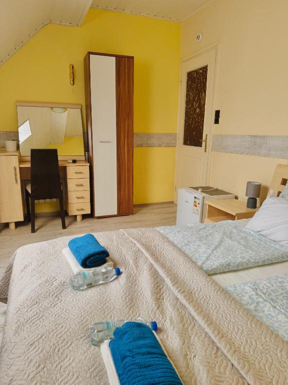 a bedroom with a bed with two blue towels on it at Sailor's Apartman in Siófok