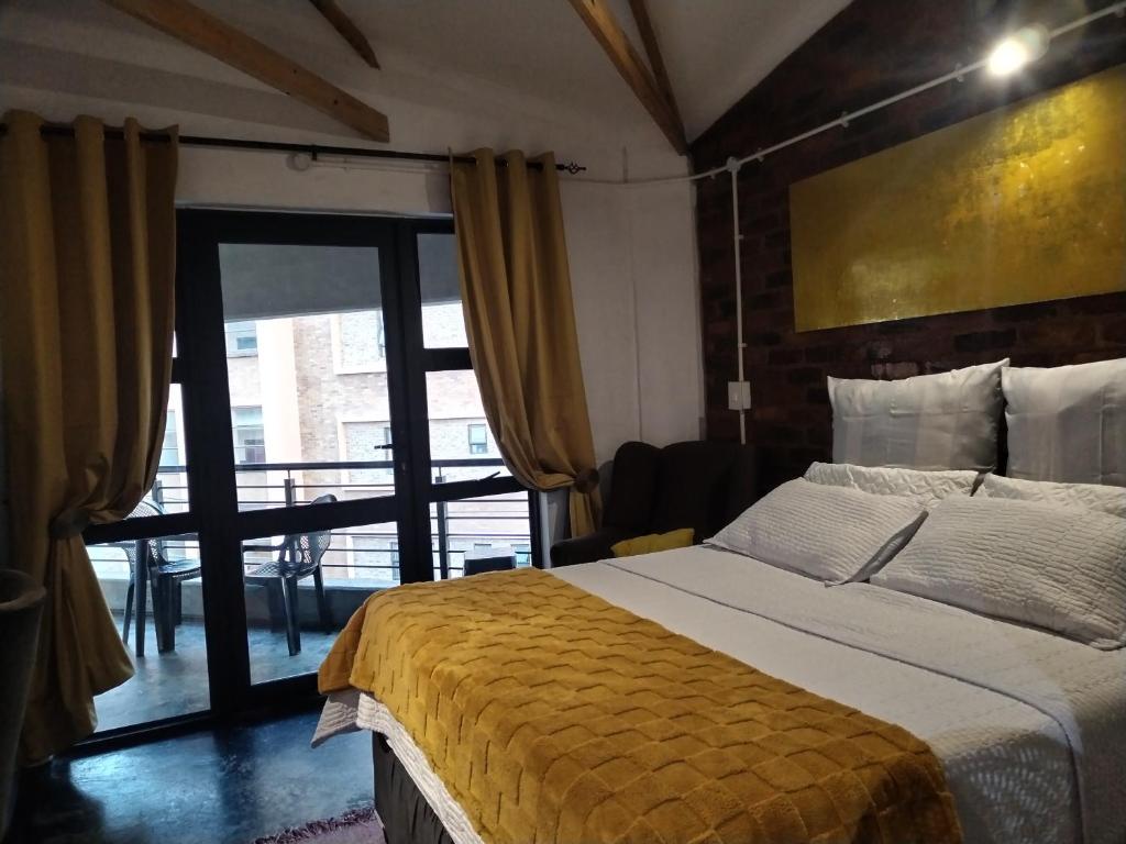 a bedroom with a large bed and a large window at 260 Jozi Maboneng - Uncapped Wi-Fi in Johannesburg