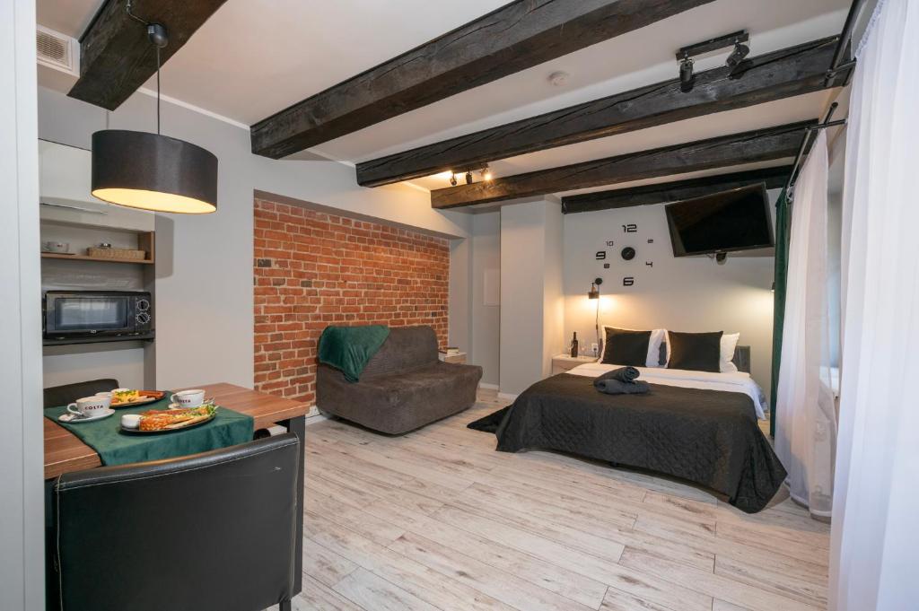 Posteľ alebo postele v izbe v ubytovaní Kościelna Loft Apartaments
