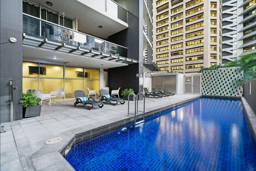 a large swimming pool in the middle of a building at Banksys Hideout London Graffiti-Style Apartment in Brisbane