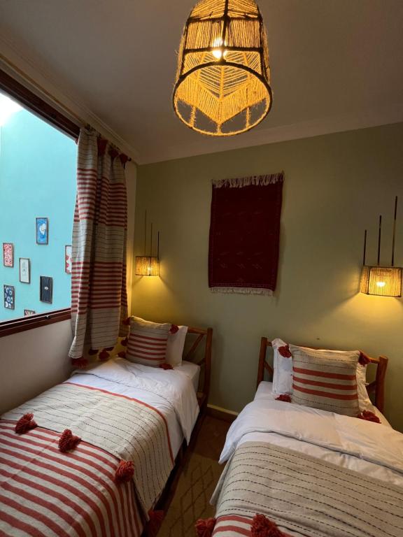 Postel nebo postele na pokoji v ubytování hostel riad maqam