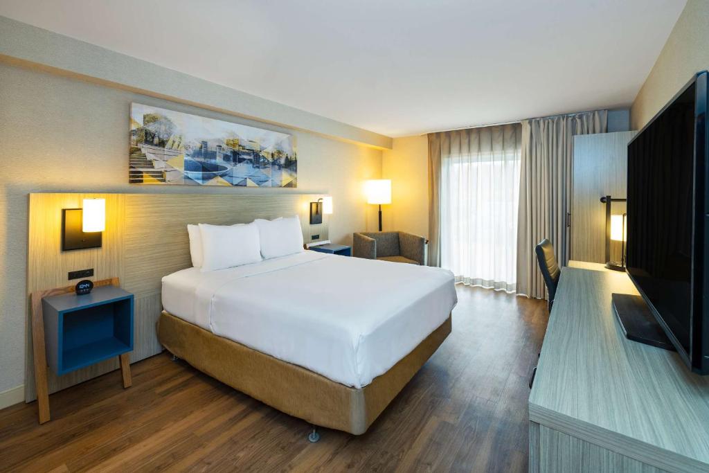 a hotel room with a bed and a television at Comfort Inn in Amherst
