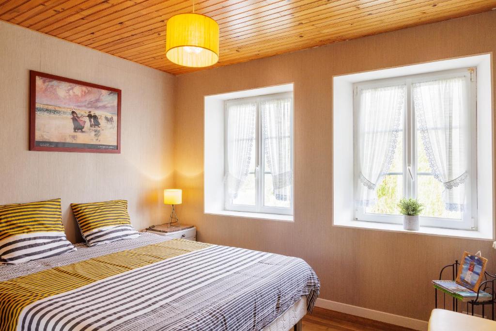 Postel nebo postele na pokoji v ubytování ARVEIL