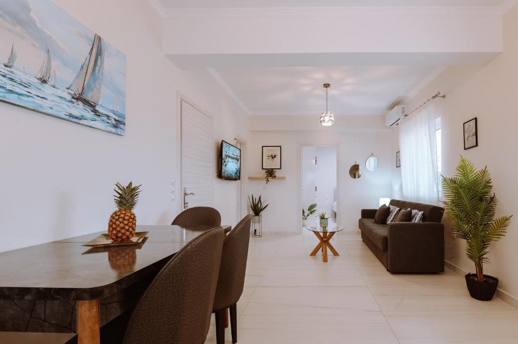 a living room with a table and a couch at Esperides Luxury Suites 3 in Kalamitsi