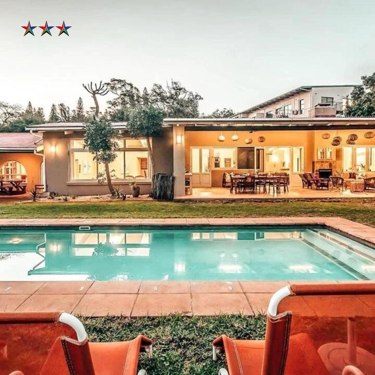 an image of a house with a swimming pool at Ngoye Lodge in Mtunzini