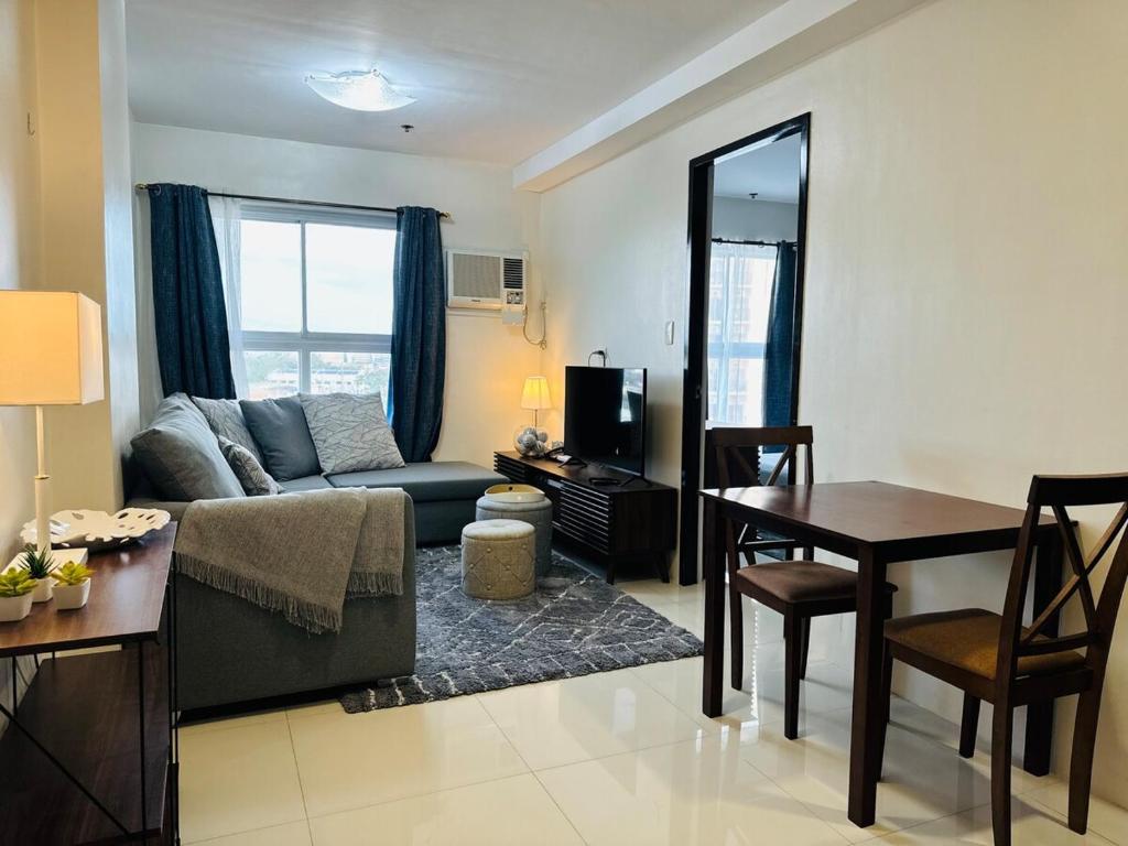 a living room with a couch and a table at 1 Bedroom Unit In Bamboo Bay in Mandaue City